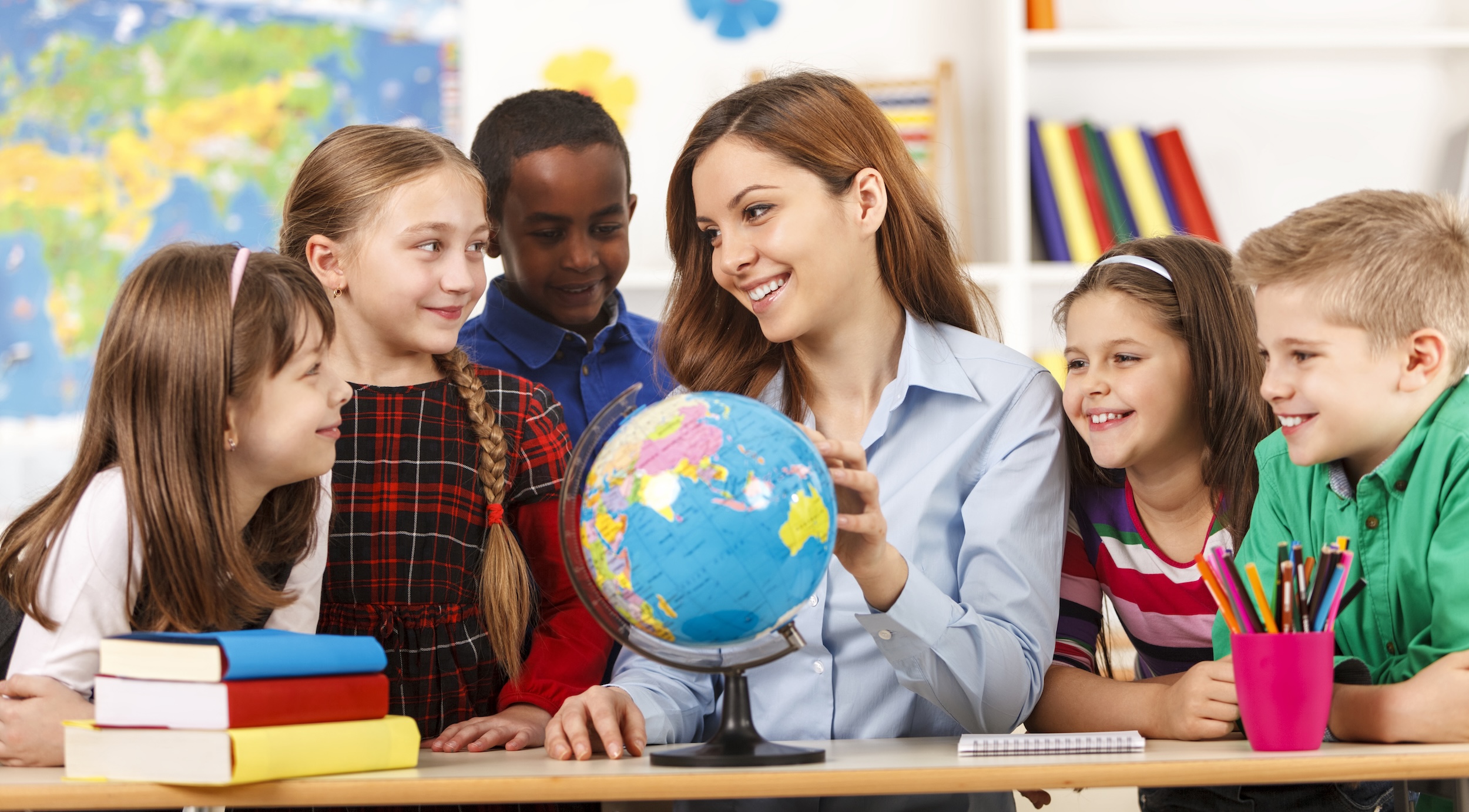 African American man with globe teaching students